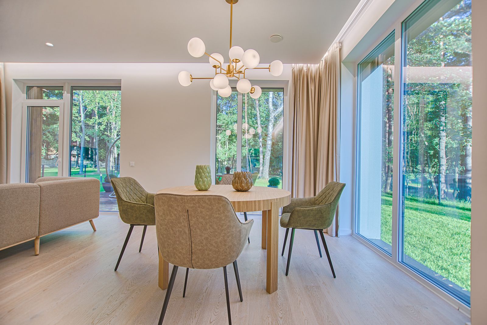 Salle à manger, table ronde bois et fauteuils vert olive